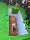 The flywhisk and the hat resting on Raila's coffin in his grave