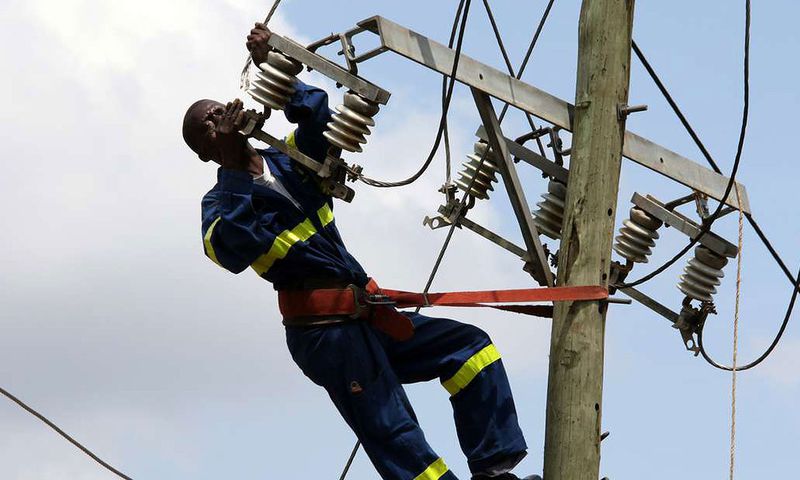 Kenya Power staff fixing a transmission line