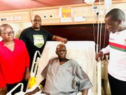 Matthew Nyamlori sorrounded by friends in hospital