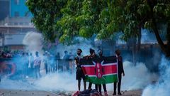 Young protesters standing in solidarity with their fallen comrade after the Occupy Parliament protests on June 25, 2024, in Nairobi.