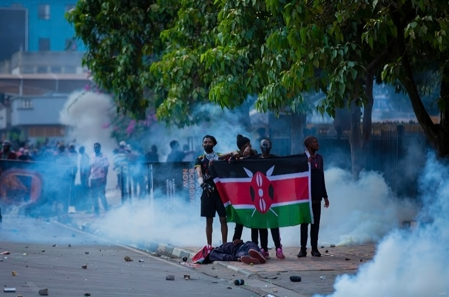 Young protesters standing in solidarity with their fallen comrade after the Occupy Parliament protests on June 25, 2024, in Nairobi.