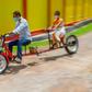 Self-made automobile engineer Partha Saha (L) built a motorbike designed for social distancing
