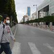 A man wears a face mask to protect against the COVID-19 disease in the Tunisian capital Tunis, where a curfew has already been imposed to stem the spread of the virus