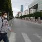 A man wears a face mask to protect against the COVID-19 disease in the Tunisian capital Tunis, where a curfew has already been imposed to stem the spread of the virus