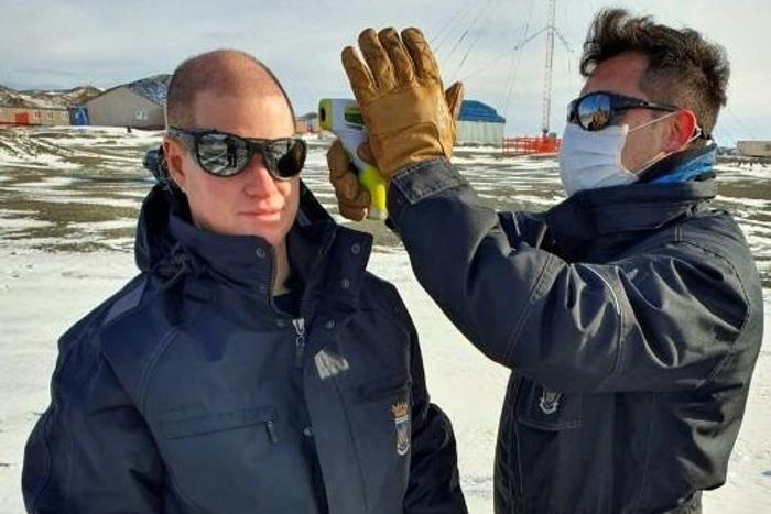 A Chilean Air Force doctor checking the temperature of personnel at the Eduardo Frei Antarctic base on the Fildes Peninsula, on May 10, 2020