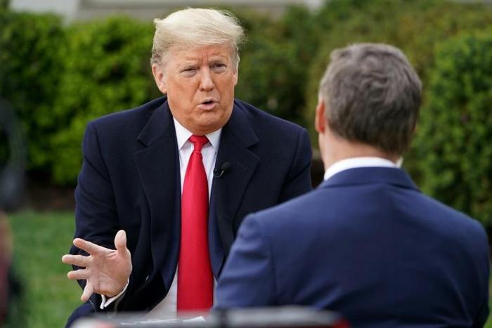US President Donald Trump (L) speaks with anchor Bill Hemmer during a Fox News virtual town hall meeting from the Rose Garden of the White House in Washington, DC, on March 24, 2020
