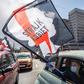 A women waves a flag from her car as part of a Warsaw protest against further tightening Poland's already restrictive abortion laws