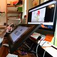 Artist Reem Ali Adeeb gestures while pointing out the Netflix production of "Green Eggs and Ham" on which she worked, in her studio apartment in Los Angeles, California on April 29, 2020