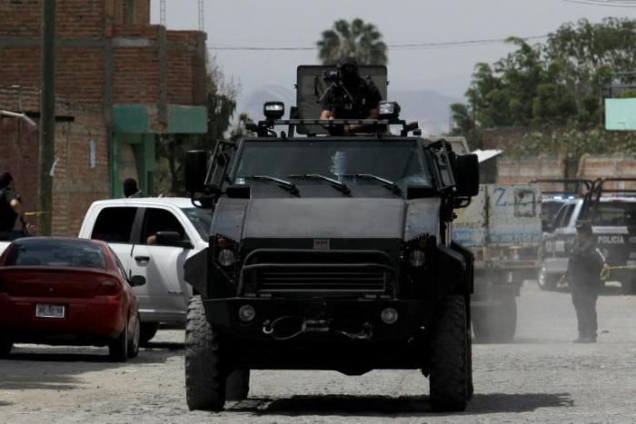 Police patrol after nine people were killed in the La Huertas neighborhood of Tlaquepaque, Mexico