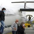 Passengers wearing masks get off a plane at Zagreb International Airport Croatia, on May 11, 2020