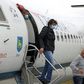 Passengers wearing masks get off a plane at Zagreb International Airport Croatia, on May 11, 2020