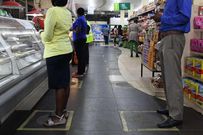 File image of customers at a Kenyan supermarket observing social distancing rules