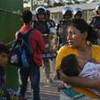 Honduran migrants wait to cross the international border bridge from Ciudad Tecun Uman in Guatemala to Ciudad Hidalgo in Mexico in January 2020