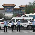 Police guard a Beijing market linked to a new coronavirus cluster