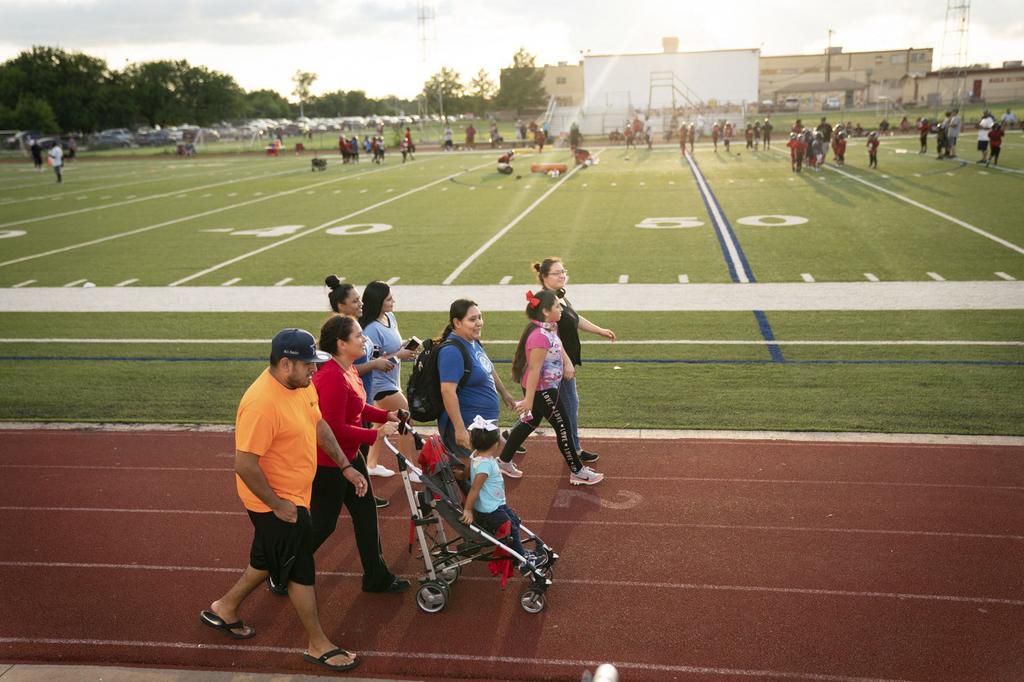 Activist Roxanne Martinez, wearing backpack, walks on a track in Fort Worth.