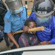 A protestor is pushed into a vehicle after being arrested