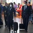 Airline staff wear protective face masks at Santiago international airport, Chile, on March 14, 2020.