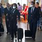 Airline staff wear protective face masks at Santiago international airport, Chile, on March 14, 2020.