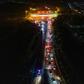 Cars queueing at a highway toll station in Wuhan in China's central Hubei province, as they prepare to leave the city after authorities lifted a more than two-month ban on outbound travel