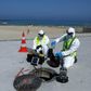 Technicians from Israeli firm Kando extract sewage samples from a manhole near the beach, in the southern coastal Israeli city of Ashkelon
