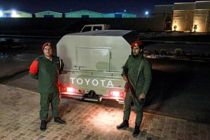 Military police loyal to strongman Khalifa Haftar stand guard earlier this month outside a vehicle allegedly containing arrested Syrian mercenaries
