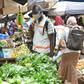 The defiant mood is deepened by the need to make a living. At a Conakry market, the Red Cross spreads the word on fighting the virus