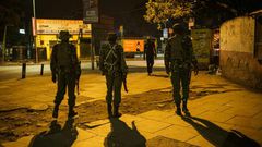 On patrol: Police in central Nairobi during the 7pm-5am curfew