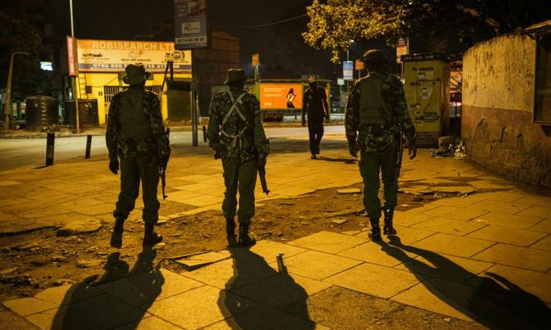On patrol: Police in central Nairobi during the 7pm-5am curfew