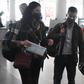 Wall Street Journal reporters Julie Wernau (L), Stu Woo (C) and Stephanie Yang walk through Beijing Capital Airport before departing