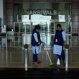 Staff clean the arrivals terminal at Cochin International Airport in Kochi ahead of the arrival of a first repatriation flight carrying Indian citizens from the Gulf