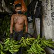 A man wears a face mask as he works at a market in Medellin, Colombia, on March 19, 2020