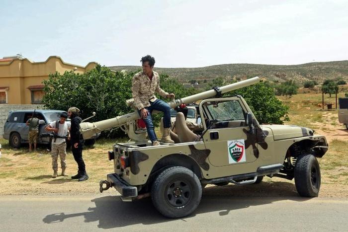Fighters for Libya's UN-recognised Government of National Accord (GNA) gather at a position near the town of Garabulli, some 70km east of the capital Tripoli, amid battles with forces loyal to the Libyan strongman Khalifa Haftar earlier this month