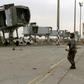 A fighter loyal to Libya's UN-recognised unity government  surveys the abandoned jet bridges at Tripoli's devastated civilian airport following its recapture on Wednesday