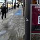 Commuters walk past a sign warning about the COVID-19 at San Ysidro port of entry, in Tijuana, Baja California state, Mexico