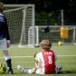 Dutch children play football during the first reopening day of youth training camps in the Netherlands after the coronavirus covid-19 outbreak in The Hague, on April 29, 2020