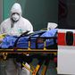 Medical workers stretch a patient from an Italian Red Cross ambulance into an intensive care unit set up in a sports center outside the San Raffaele hospital in Milan, on March 23, 2020 during the COVID-19 new coronavirus pandemic. (Photo by Miguel MED...