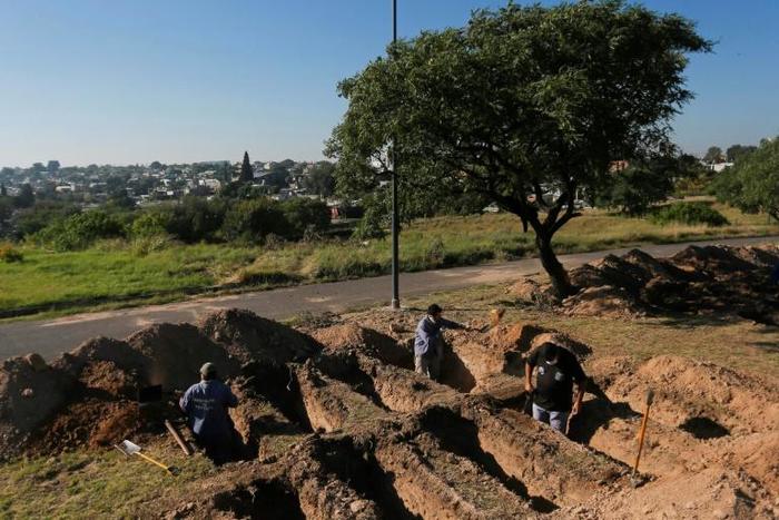 Grave diggers prepare plots at the San Vicente cemetery in Cordoba following a spike in coronavirus cases