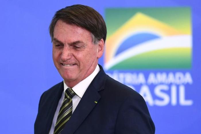 Brazilian President Jair Bolsonaro gestures during the inauguration ceremony of Andre Mendonca as new Justice Minister at Planalto Palace in Brasilia, on April 29, 2020
