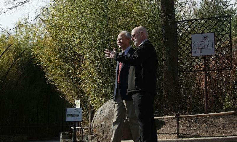 Chinese Ambassador Cui Tiankai (left) speaks to the director of the National Zoo, Dennis Kelly, as they wait for the departure of giant panda Bao Bao in February 2017