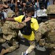 Protesters and members of the Army National Guard kneel together in Los Angeles on June 2, 2020 during a demonstration over the killing of George Floyd