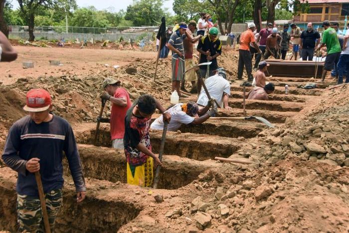 Workers dig graves at the Caminos del Cielo cemetery in Managua on May 23, 2020