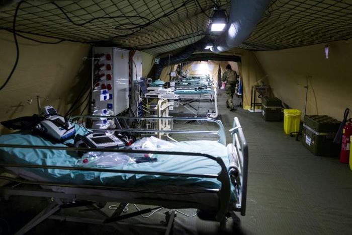 French soldiers install medical beds at the military field hospital set up outside the Emile Muller Hospital in Mulhouse, eastern France