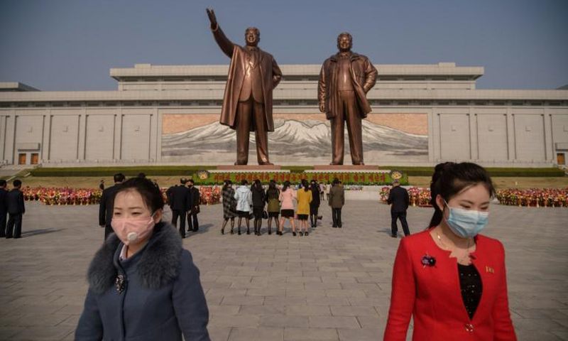 Pyongyang residents pay their respects at the giant bronze statues of Kim Il Sung and his son and successor Kim Jong Il