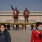 Pyongyang residents pay their respects at the giant bronze statues of Kim Il Sung and his son and successor Kim Jong Il