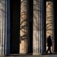 A guard walks past the columns of a memorial in Berlin that will figure in VE day ceremonies