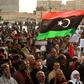 Supporters of Libyan military strongman Khalifa Haftar wave a national flag in a February 2020 demonstration in Benghazi