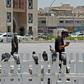 A masked man checks his phone in Qatar where residents and citizens have been required by law to install a coronavirus contact tracing app on their handsets since Friday