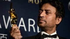 Irrfan Khan poses with a statuette for Best Actor at the 2014 Asian Film Awards