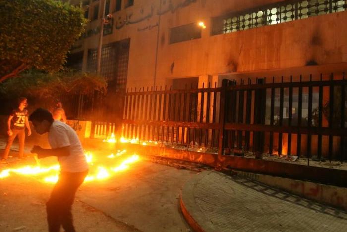 Lebanese protesters throw Molotov cocktails the branch of the central bank in the southern city of Sidon