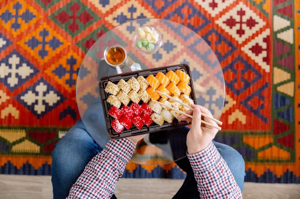 Eating sushi at home, directly above personal perspective view